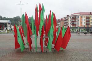 Red and green flags on a stand in the city. Decorations for the holiday photo
