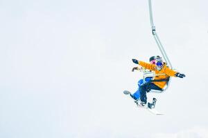 Gudauri, Georgia - 15th february, 2024 - two friends in ski lift pose go up isolated in white snowy background mock up photo