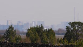 An airliner with an unrecognizable livery landing, touching down and braking. Haze creates poor visibility video