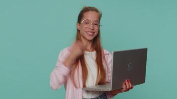 criança menina trabalhando conectados em computador portátil, mostrando polegar acima para Câmera, positivo comentários como, loteria ganhar video