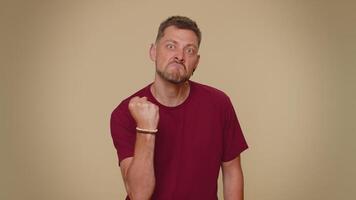 Aggressive angry man trying to fight at camera, shaking fist, boxing with expression, punishment video