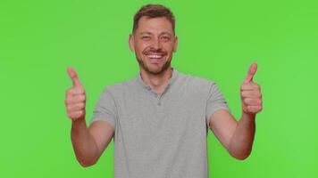 Man raises thumbs up agrees or gives positive reply recommends advertisement likes good, approve video