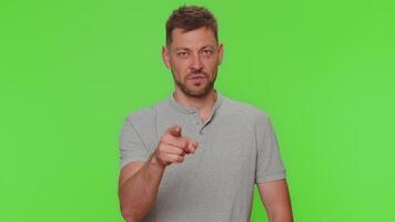 Handsome young man pointing to camera and looking with playful happy expression, making choice video