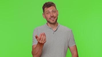 Man guy showing a little bit gesture with sceptic smile, showing minimum sign, measuring small size video