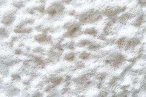 The styrofoam texture background features a pattern of tiny, interconnected foam beads with a subtle grainy surface photo