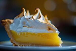 A delicious slice of lemon meringue pie, topped with a fluffy golden meringue photo