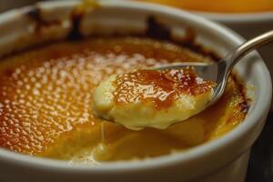 A perfectly caramelized sugar crust tops a smooth creme brulee photo