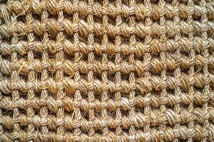 A jute texture background features a coarse, natural fiber with a rustic and earthy appearance photo