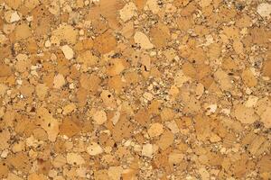 A cork texture background features a natural, earthy surface with a distinct grainy pattern photo