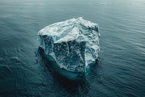 A lonely iceberg breaking off in the sea, global warming, an environmental disaster, melting glaciers. photo