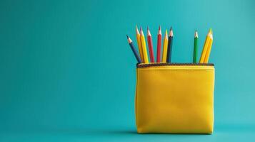 Yellow pencil case with colorful pencils photo