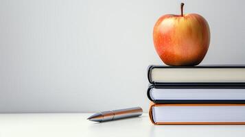 Apple and four books and a pen photo