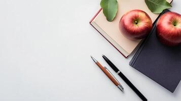 Apple and four books and a pen photo