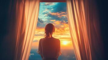 A woman standing by a window photo