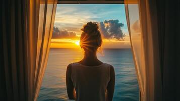 A woman standing by a window photo
