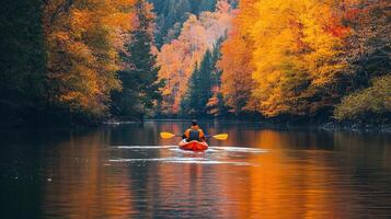 Lone kayaker paddling down a tranquil river photo