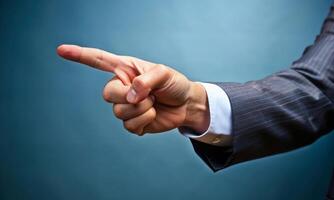 The businessman's index finger points to something in space photo
