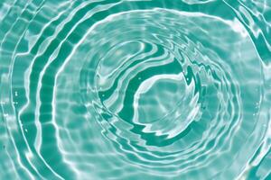 Bluewater waves on the surface ripples blurred. Defocus blurred transparent blue colored clear calm water surface texture with splash and bubbles. Water waves with shining pattern texture background. photo