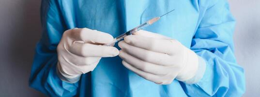 Cropped shot of healthcare worker holding a syringe before injection vaccine or medicine to patients. photo