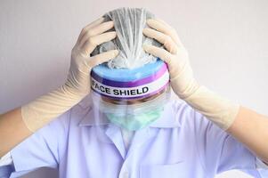 Portrait of Nurse or Doctor having headache and stress from working. The wellbeing and emotional resilience are key components of maintaining essential care services during the COVID-19 pandemic. photo