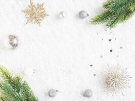 Flat lay frame various green and silver christmas decor on artificial snow background photo
