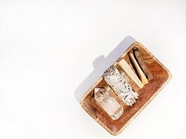 Items for spiritual cleansing - sage bundle, palo santo incense sticks and quartz crystal photo