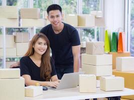 A young couple is working in the office. Teamwork and using various technologies internet for the business efficiency whether it is a website and social media. Business and teamwork concept photo