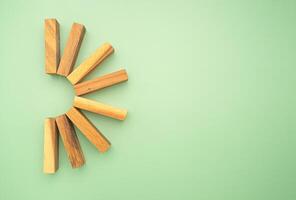 Top view of empty eight wooden blocks isolated on a green background photo