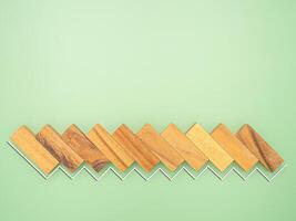Top view of empty wooden blocks with white line effect isolated on a green background. Space for text photo