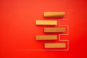 Top view of five empty wooden blocks with line effect isolated on a red background. Space for text photo