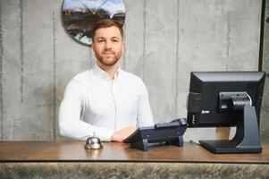 Portrait of receptionist at desk in lobby photo