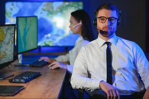 Photo of a successful dispatcher working on a computer in the office