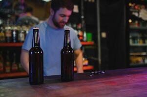 Portrait Of Smiling Male Bar Owner Standing Behind Counter photo