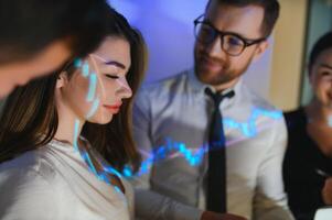 Group of business people working. Technical price graph and indicator, red and blue candlestick chart and stock trading computer screen background. Traders analyzing data photo