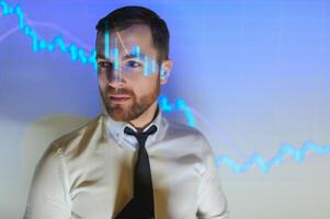 Stock Market Trader Working Investment Charts, Graphs, Ticker, Diagrams Projected on His Face. Financial Analyst and Digital Businessman Selling Shorts and Buying Longs photo