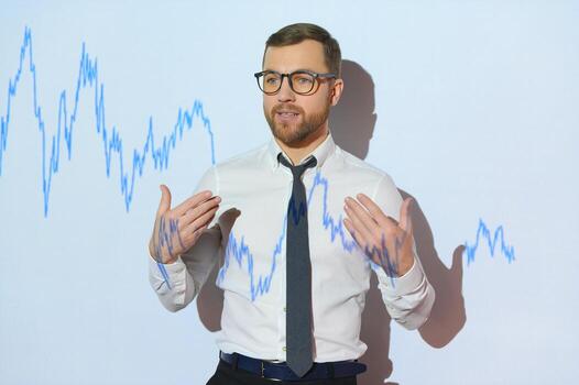 Man is standing near projector and showing graphs and business graphs. photo