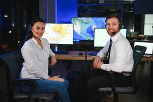 Diverse call center operators team use computers consulting clients in office photo