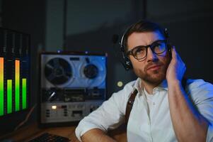 Secret agent listens on the reel tape recorder. Officer wiretapping in headphones. Spying of conversations. Intelligence gathering. Espionage concept photo