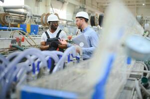Two workers at the factory. Engineer and worker photo