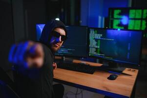 Hacker is hacking into the computer network. Computer criminal photo