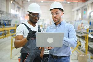 Two workers at the factory. Engineer and worker photo