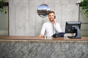 Receptionist at desk in lobby photo