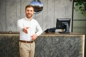 Portrait of receptionist at desk in lobby, hotel photo