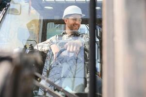 Man worker at forklift driver happy working in industry factory logistic ship photo