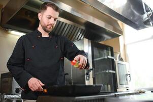 Smiling chef in his kitchen photo