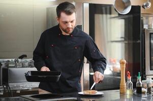 Smiling chef in his kitchen photo