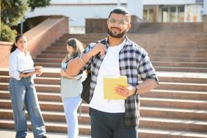 Happy indian male student at the university photo