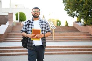 Happy indian male student at the university photo