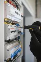 Close-up of electrician working on circuitry photo