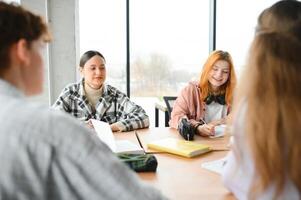 Group of college students doing homework photo
